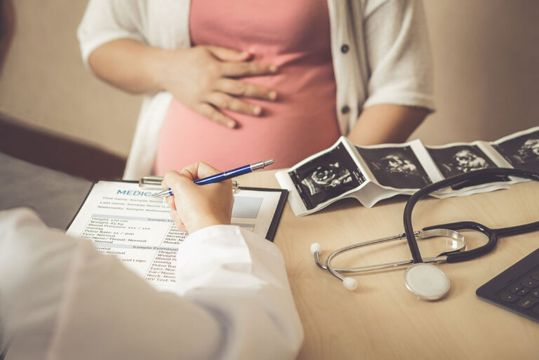pregnant woman consulting with doctor
